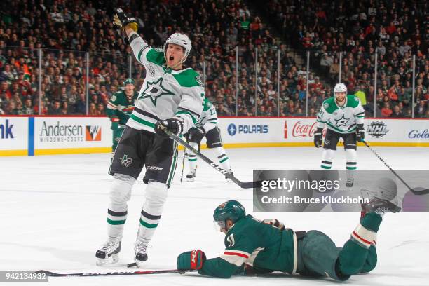 John Klingberg of the Dallas Stars trips Zach Parise of the Minnesota Wild during the game at the Xcel Energy Center on March 29, 2018 in St. Paul,...