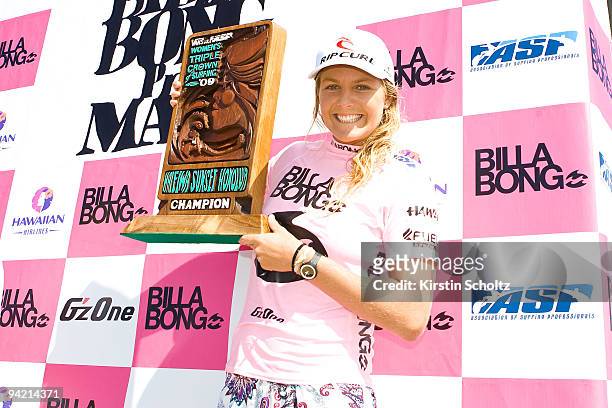 Stephanie Gilmore of Australia holds up her Vans Triple Crown of Surfing trophy, clinching the title after winning the Billabong Pro Maui on December...