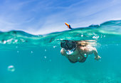 Woman exploring the sea while snorkeling in summer day.