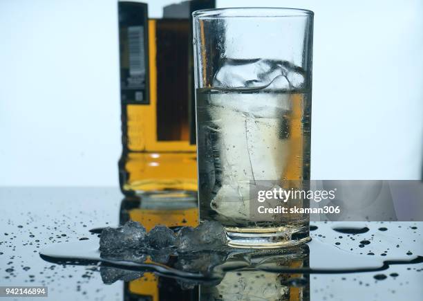 selective focus drink alcohol and water glass with whisky and sparking water and ice cube - whiskey tasting stock pictures, royalty-free photos & images