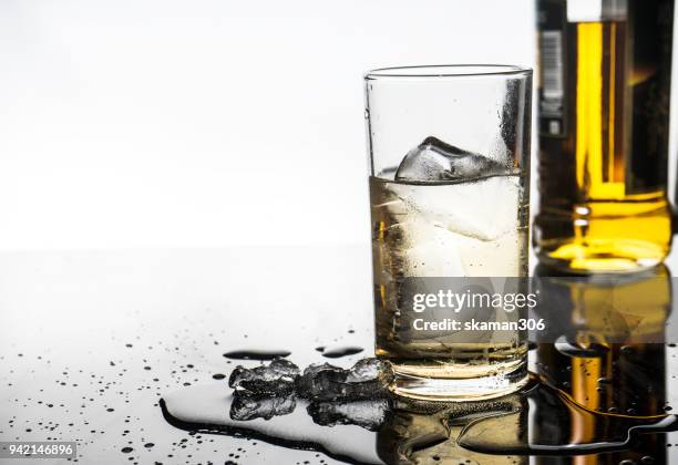 selective focus drink alcohol and water glass with whisky and sparking water and ice cube - whiskey tasting stock pictures, royalty-free photos & images
