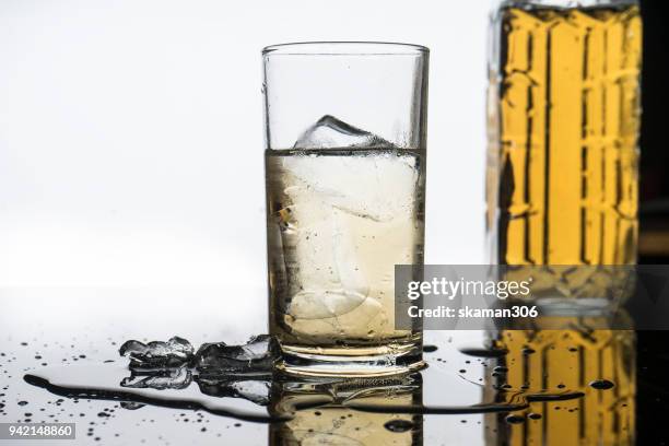 selective focus drink alcohol and water glass with whisky and sparking water and ice cube - whiskey tasting stock pictures, royalty-free photos & images