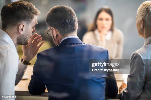 come closer, what do you think about this candidate? - people whispering imagens e fotografias de stock