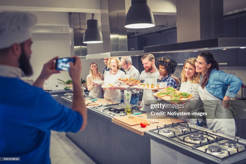 Chef is photographing attendees of cooking class