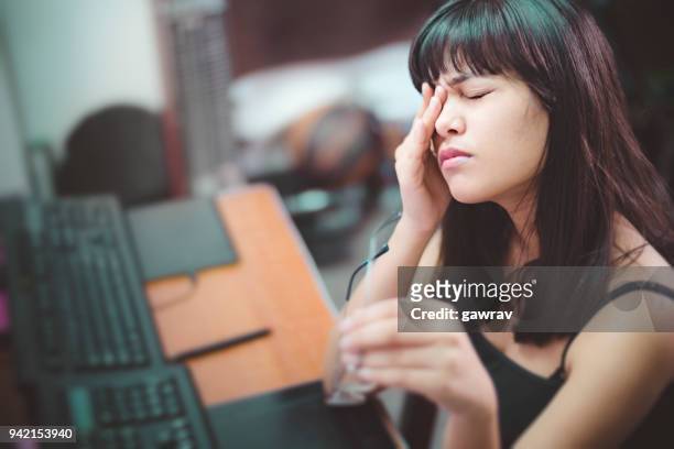 young woman with aching eyes after working on computer. - rubbing stock pictures, royalty-free photos & images