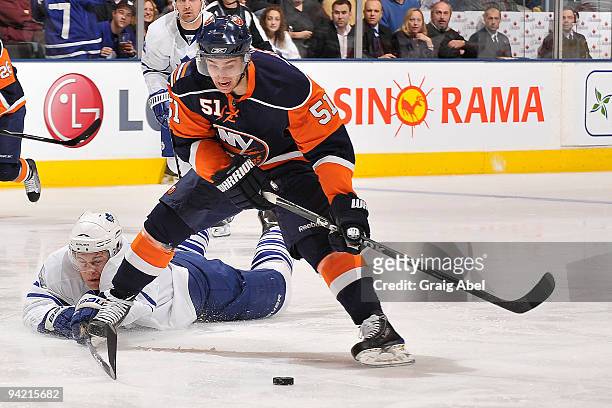 Luke Schenn of the Toronto Maple Leafs dives to knock the puck away from Frans Nielsen of the New York Islanders during game action December 9, 2009...