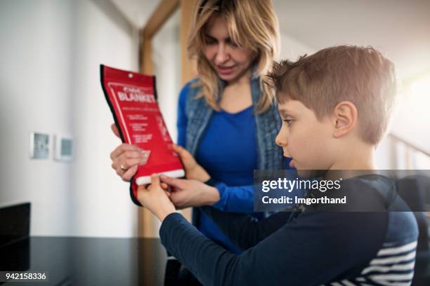 mother explaining fire to her son - fire uk stock pictures, royalty-free photos & images