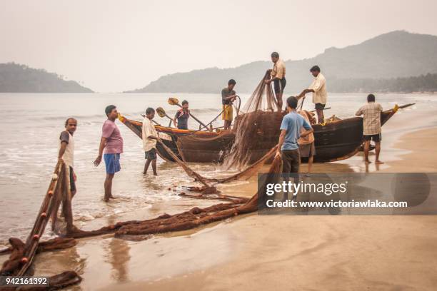 detangling the net - palolem beach stock pictures, royalty-free photos & images