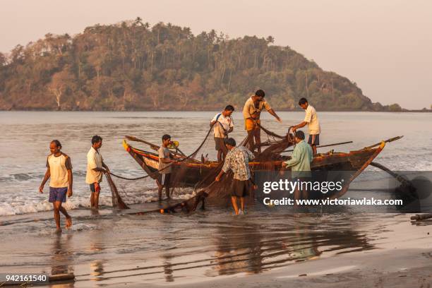 fishermen at work in palolem beach - palolem beach stock pictures, royalty-free photos & images