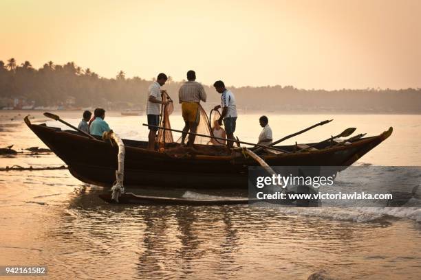 fishing boat during sunrise in palolem beach - palolem beach stock pictures, royalty-free photos & images