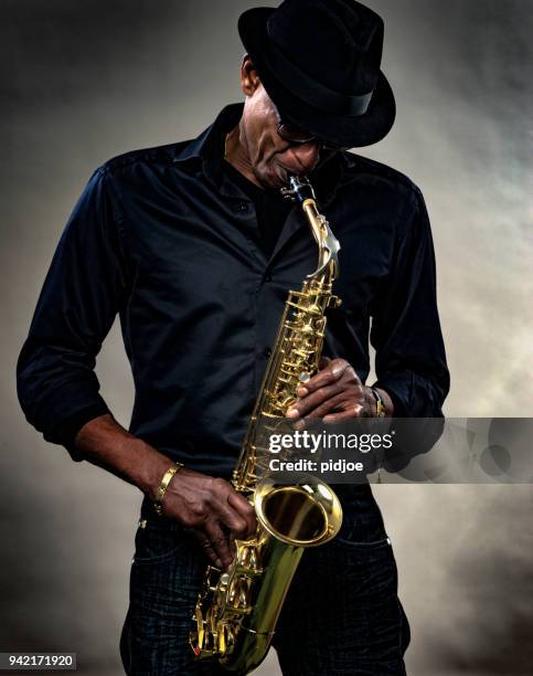 musician with saxophone - saxophone stock pictures, royalty-free photos & images
