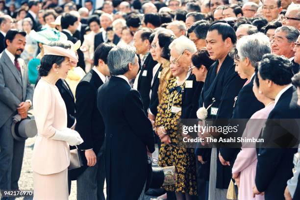 Emperor Akihito and Empress Michiko talk with sumo yokozuna Chiyonofuji during the Spring Garden Party at the Akasaka Imperial Garden on May 31, 1990...