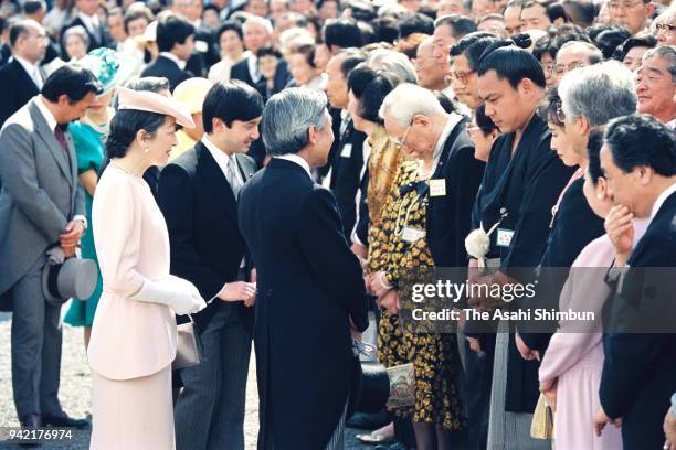 Emperor Akihito and Empress Michiko talk with sumo yokozuna Chiyonofuji during the Spring Garden Party at the Akasaka Imperial Garden on May 31, 1990...