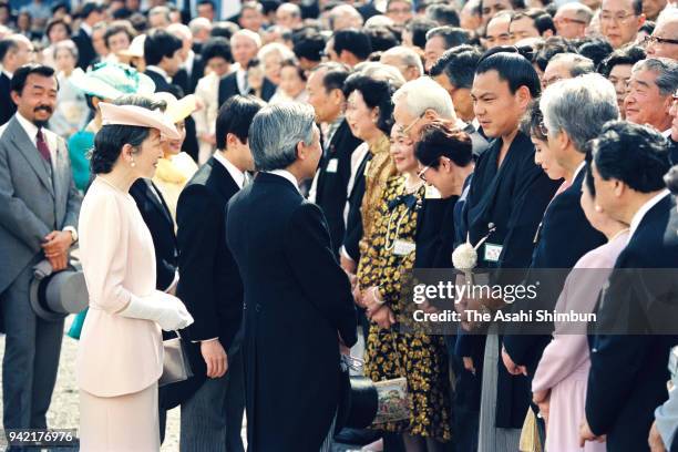 Emperor Akihito and Empress Michiko talk with sumo yokozuna Chiyonofuji during the Spring Garden Party at the Akasaka Imperial Garden on May 31, 1990...