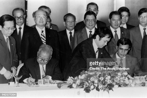 Prince Norodom Sihanouk of Cambodia and Prime Minister Hun Sen sign documents during the Tokyo Meeting on Cambodia at the Akasaka State Guesthouse on...