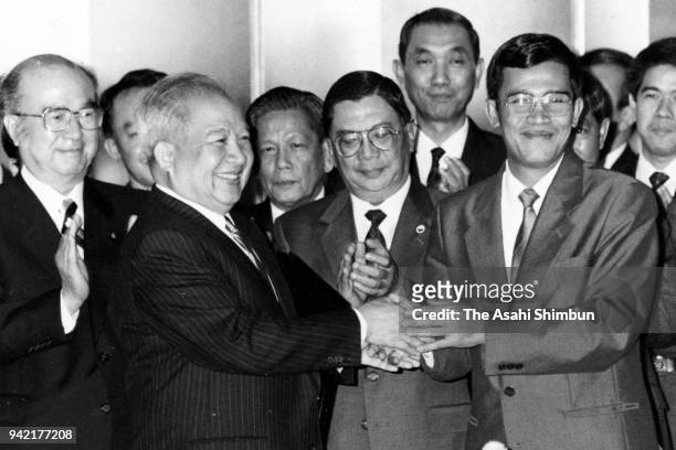 Prince Norodom Sihanouk of Cambodia and Prime Minister Hun Sen shake hands after signing documents during the Tokyo Meeting on Cambodia at the...