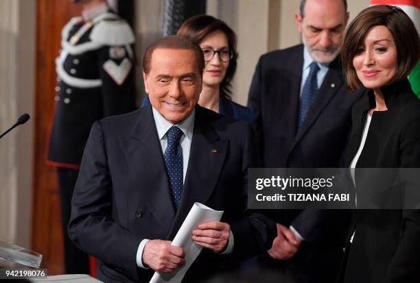 Silvio Berlusconi , leader of the right-wing party "Forza Italia" flanked by Anna Maria Bernini leaves after a meeting with Italian President Sergio...