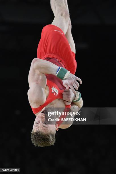 Britain's Nile Wilson competes on the floor exercise during the men's team final in the artistic gymnastics event during the 2018 Gold Coast...