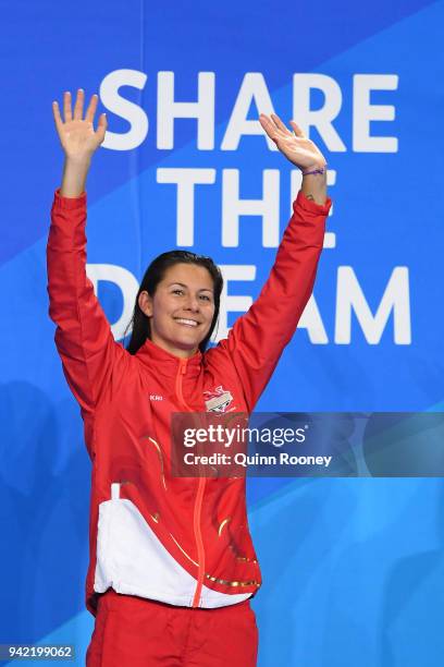 Gold medalist Aimee Willmott of England waves during the medal ceremony for the Women's 400m Individual Medley Final on day one of the Gold Coast...