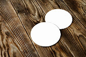 Two blank beer coasters on wooden rustic table background. Blank for new design, mock up