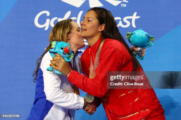 Silver medalist Hannah Miley of Scotland embraces gold medalist Aimee Willmott of England during the medal ceremony for the Women's 400m Individual...