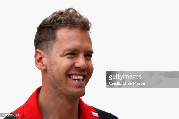 Sebastian Vettel of Germany and Ferrari smiles in the Paddock during previews ahead of the Bahrain Formula One Grand Prix at Bahrain International...