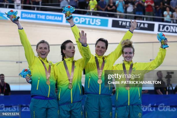 Australia's Ashlee Ankudinoff, Annette Edmondson, Amy Cure and Alexandra Manly celebrate on the podium with their gold medals in the women's 4000m...