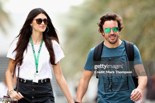 Fernando Alonso of Spain and McLaren F1 walks in the Paddock with girlfriend Linda Morselli during previews ahead of the Bahrain Formula One Grand...