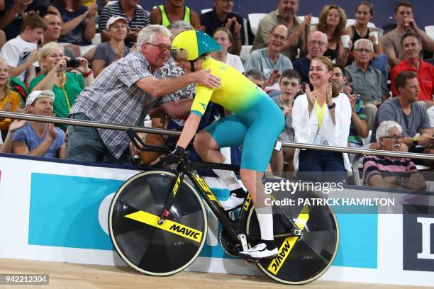 Australia's Annette Edmondson is congratulated by her father after her team won gold in the women's 4000m team pursuit finals track cycling event...