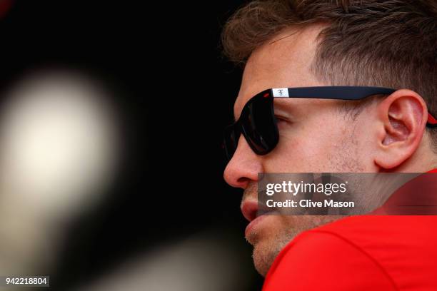 Sebastian Vettel of Germany and Ferrari looks on in the Paddock during previews ahead of the Bahrain Formula One Grand Prix at Bahrain International...