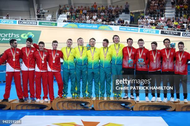Australia , England and Canada teams pose on the podium for their respective gold, silver and bronze medal wins in the men's 4000m team pursuit...