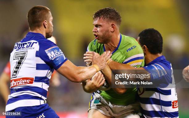 Elliot Whitehead of the Raiders is tackled during the round five NRL match between the Canberra Raiders and the Canterbury Bulldogs at GIO Stadium on...