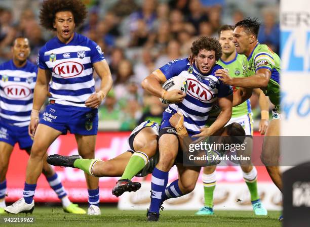 Adam Elliot of the Bulldogs is tackled during the round five NRL match between the Canberra Raiders and the Canterbury Bulldogs at GIO Stadium on...