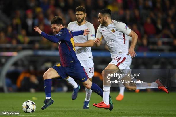 Lionel Messi of Barcelona gets away from Federico Fazio and Konstantinos Manolas of Roma during the UEFA Champions League Quarter Final Leg One...