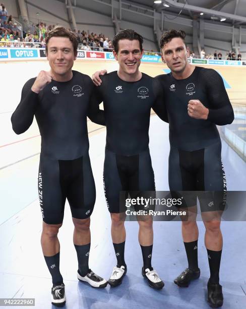 Edward Dawkins, Ethan Mitchell and Sam Webster of New Zealand celebrate winning gold in the Men's Team Sprint Finals during the Cycling on day one of...