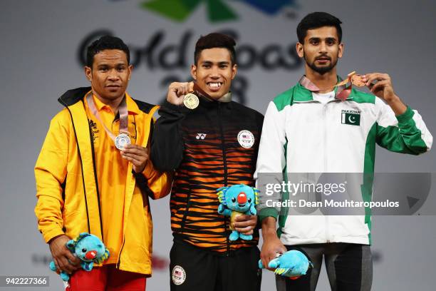Silver medalist, Morea Baru of Papua New Guinea, gold medalist Muhamad Aznil Bidin of Malaysia and bronze medalist Talha Talib of Pakistan pose...