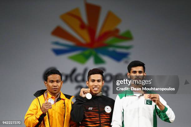 Silver medalist, Morea Baru of Papua New Guinea, gold medalist Muhamad Aznil Bidin of Malaysia and bronze medalist Talha Talib of Pakistan pose...