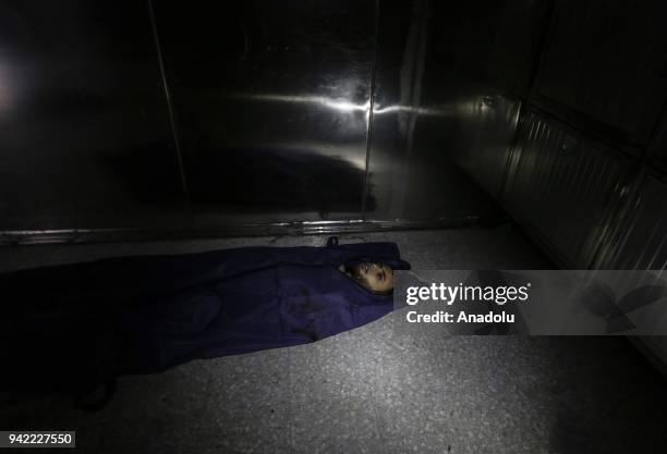 Dead body of 23-year-old Palestinian Nabil al- Hadri who has been killed in Israeli airstrike on Gaza laying on the floor in the morgue at Al-Shifa...