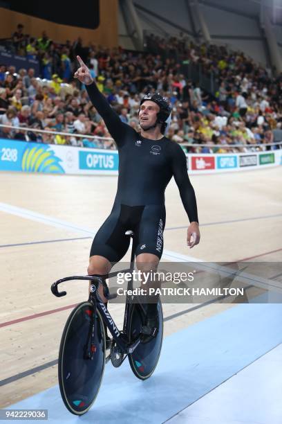 New Zealand's Edward Dawkins celebrates his team's gold medal win in the men's team sprint finals track cycling event during the 2018 Gold Coast...