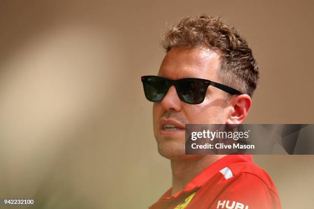 Sebastian Vettel of Germany and Ferrari talks in the Paddock during previews ahead of the Bahrain Formula One Grand Prix at Bahrain International...