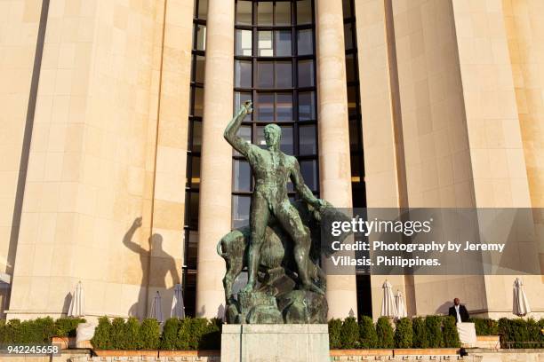 hercules and the bull statue, trocadero gardens - hercules named work stockfoto's en -beelden