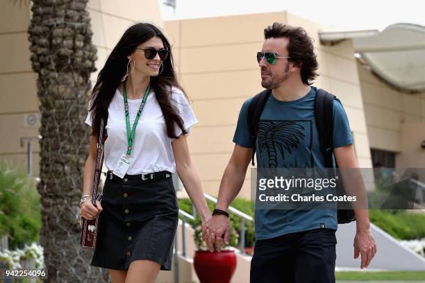 Fernando Alonso of Spain and McLaren F1 walks in the Paddock with girlfriend Linda Morselli during previews ahead of the Bahrain Formula One Grand...