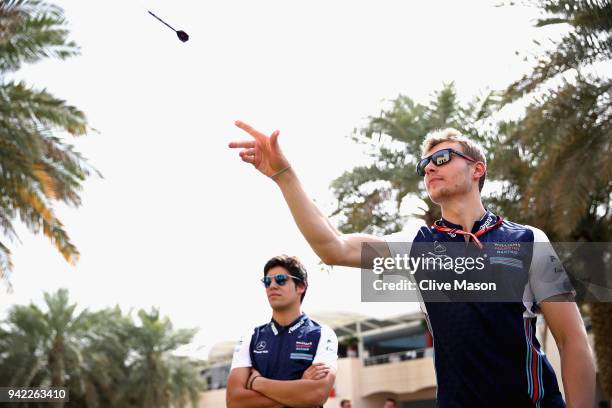 Sergey Sirotkin of Russia and Williams plays darts in the Paddock during previews ahead of the Bahrain Formula One Grand Prix at Bahrain...