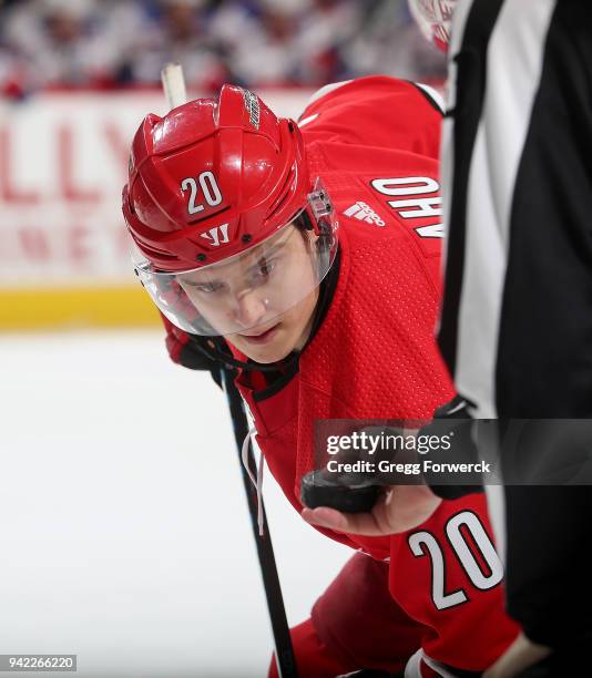 Sebastian Aho of the Carolina Hurricanes prepares to take a face off during an NHL game against the New York Rangers on March 31, 2018 at PNC Arena...