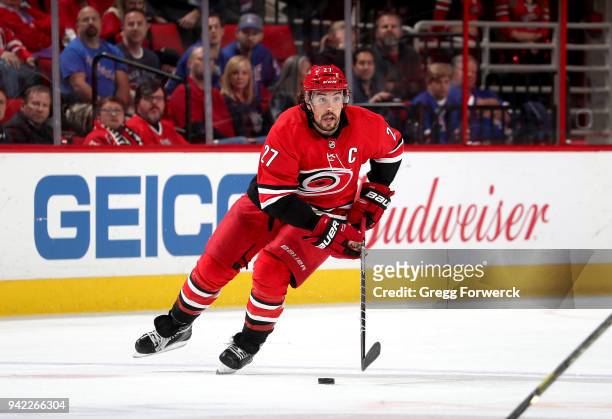 Justin Faulk of the Carolina Hurricanes skates with the puck during an NHL game against the New York Rangers on March 31, 2018 at PNC Arena in...