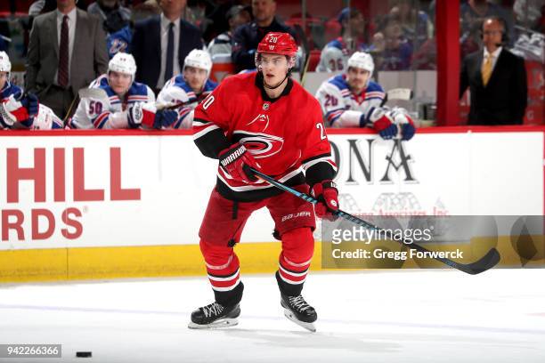 Sebastian Aho of the Carolina Hurricanes skates for a loose puck during an NHL game against the New York Rangers on March 31, 2018 at PNC Arena in...