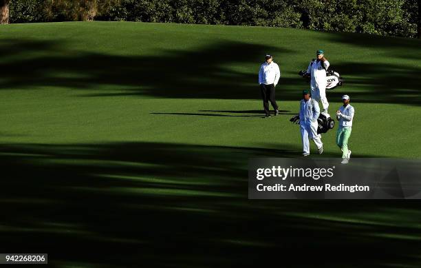 Wesley Bryan of the United States and Ted Potter Jr. Of the United States walk with their caddies John Balmer and William Lanier on the second hole...