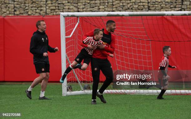 Jake Clarke-Salter uses his height against an under 9 player during a training session between the First Team and the under 9's at The Academy of...