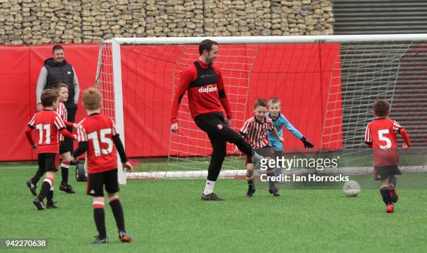 John O'Shea takes on under 9 players against the first team during a training session between the First Team and the under 9's at The Academy of...