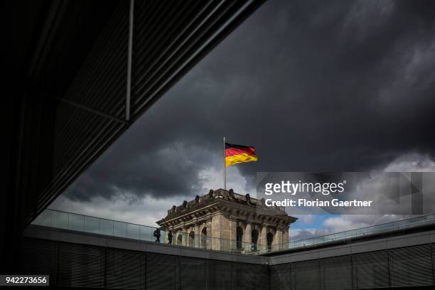 The german flag waves on the top of the Reichstag building on April 05, 2018 in Berlin, Germany.